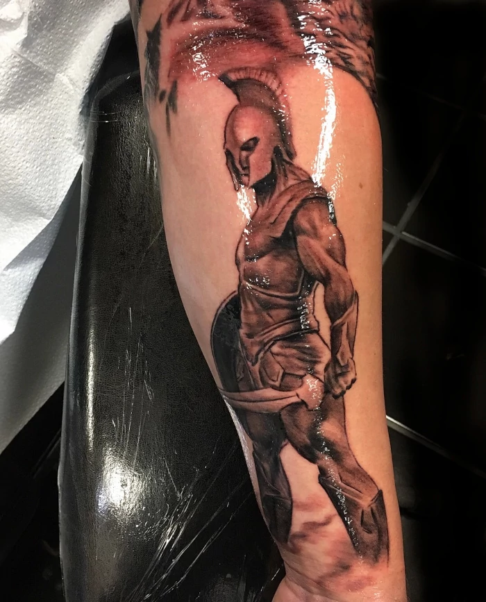 Gladiator forearm tattoo done in black and grey ink by tattoo artist Russ Howie of Sacred Mandala Studio in Durham, NC.